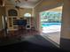 Open-concept living space with a view of the screened-in pool and outdoor area at 9127 Woodridge Run Dr, Tampa, FL 33647