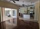 Open living room with hardwood floors flowing into kitchen with island at 9127 Woodridge Run Dr, Tampa, FL 33647
