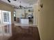 Open living room with hardwood floors flowing into kitchen with island at 9127 Woodridge Run Dr, Tampa, FL 33647