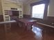 Inviting living room with a pool table, custom built-ins, and a large window for natural light at 9127 Woodridge Run Dr, Tampa, FL 33647