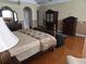 Generously sized primary bedroom with hardwood floors and classic furniture at 9127 Woodridge Run Dr, Tampa, FL 33647
