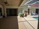 Covered patio area with a screened-in pool, seating, and space for entertaining at 9127 Woodridge Run Dr, Tampa, FL 33647