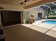 Outdoor living space with a covered patio area, a screened-in pool, and ample seating at 9127 Woodridge Run Dr, Tampa, FL 33647