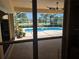View from indoors to the screened-in pool and patio area with mature landscaping at 9127 Woodridge Run Dr, Tampa, FL 33647