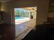 View from the kitchen of the screened-in pool, patio, and outdoor living area at 9127 Woodridge Run Dr, Tampa, FL 33647