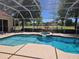 Enclosed swimming pool and spa with an adjacent golf course view at 9127 Woodridge Run Dr, Tampa, FL 33647