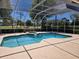 Screened-in pool area with a built-in spa and a view of the golf course at 9127 Woodridge Run Dr, Tampa, FL 33647