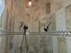 Walk in shower with a stone pebble floor, dual shower heads and decorative stone tiles at 9127 Woodridge Run Dr, Tampa, FL 33647