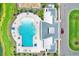 Aerial view of community pool with lounge chairs, splash area, and clubhouse at 1015 7Th Nw Ave, Ruskin, FL 33570