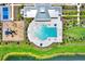 Aerial view of community pool featuring sun loungers and splash area at 1015 7Th Nw Ave, Ruskin, FL 33570