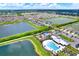 Beautiful aerial view of community featuring multiple ponds, playground, tennis court, and pool at 1015 7Th Nw Ave, Ruskin, FL 33570