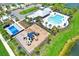 Aerial view of community pool, clubhouse, pickleball court, parking and playground at 1015 7Th Nw Ave, Ruskin, FL 33570