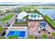 Aerial view of clubhouse, pool, playground, lake, and pickleball court at 1015 7Th Nw Ave, Ruskin, FL 33570