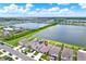 Beautiful aerial view of a suburban home next to a lake, in a community with a pool and many other amenities at 1015 7Th Nw Ave, Ruskin, FL 33570
