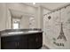 Bright bathroom featuring double sinks with granite countertops and a shower at 1015 7Th Nw Ave, Ruskin, FL 33570