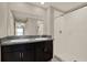 Bright bathroom featuring double sinks with granite countertops and a walk in shower at 1015 7Th Nw Ave, Ruskin, FL 33570