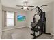 The home gym features a ceiling fan, natural light, and exercise equipment perfect for a healthy lifestyle at 1015 7Th Nw Ave, Ruskin, FL 33570