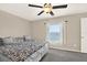 Cozy bedroom features a ceiling fan and a bright window with a view at 1015 7Th Nw Ave, Ruskin, FL 33570