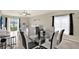 Bright dining room with a modern table set, natural light, and views of the backyard's lake at 1015 7Th Nw Ave, Ruskin, FL 33570