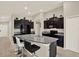 The kitchen features dark cabinets, granite countertops, stainless steel appliances, and a breakfast bar with seating at 1015 7Th Nw Ave, Ruskin, FL 33570