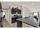 The kitchen features dark cabinets, granite countertops, stainless steel appliances, and a breakfast bar with seating at 1015 7Th Nw Ave, Ruskin, FL 33570