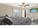 Main bedroom with a zebra-patterned bed, a ceiling fan, and a picturesque window view of a lake at 1015 7Th Nw Ave, Ruskin, FL 33570