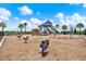 Outdoor playground featuring spring toys, swings, climbing structure, and slides at 1015 7Th Nw Ave, Ruskin, FL 33570