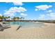 Gorgeous community pool featuring beach entry and sun loungers overlooking the lake at 1015 7Th Nw Ave, Ruskin, FL 33570