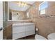 Modern bathroom with a floating vanity, large mirror, and neutral tile at 1035 58Th N Ave, St Petersburg, FL 33703