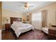 Cozy bedroom with hardwood floors, a ceiling fan, and a large window with privacy blinds at 1035 58Th N Ave, St Petersburg, FL 33703