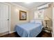 Cozy bedroom with a twin bed, hardwood floors, and a bright window at 1035 58Th N Ave, St Petersburg, FL 33703