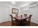 Eat-in kitchen space with wood-look flooring, overhead lighting, white walls, and table that seats four at 1035 58Th N Ave, St Petersburg, FL 33703