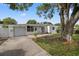 Charming single-story home featuring mature landscaping, a driveway, and an attached garage at 1035 58Th N Ave, St Petersburg, FL 33703