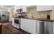 Well-lit kitchen with stainless steel appliances, white cabinets, a tile backsplash, and wood countertops at 1035 58Th N Ave, St Petersburg, FL 33703