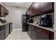The kitchen features granite countertops, dark cabinets, tile floors, and stainless steel appliances at 1035 58Th N Ave, St Petersburg, FL 33703