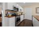 Modern kitchen showcases stainless appliances, white cabinets, wood counters, and dark wood floors at 1035 58Th N Ave, St Petersburg, FL 33703