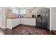Bright kitchen features white cabinets, stainless steel refrigerator, wood countertops and stylish rug at 1035 58Th N Ave, St Petersburg, FL 33703