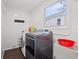 Bright laundry room equipped with modern washer and dryer, plus ample storage and a window at 1035 58Th N Ave, St Petersburg, FL 33703