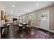 Open-concept living room and dining area with dark wood floors and lots of natural light from multiple windows at 1035 58Th N Ave, St Petersburg, FL 33703
