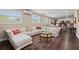 Spacious living area with a sectional sofa, dark wood floors, and a view into the kitchen and dining area at 1035 58Th N Ave, St Petersburg, FL 33703