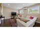 Cozy living room with a plush sectional sofa, dark wood floors, and ample natural light at 1035 58Th N Ave, St Petersburg, FL 33703