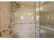 Updated shower featuring dual shower heads, a glass enclosure, and tiled walls with accent border at 1035 58Th N Ave, St Petersburg, FL 33703