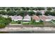 From above, a well-kept property sits next to a tranquil canal, surrounded by similar homes in a verdant, tree-filled community at 10449 Hunters Haven Blvd, Riverview, FL 33578