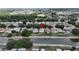 A bird's-eye view depicts a tidy home nestled in a canal-lined community, showcasing a serene and well-maintained neighborhood at 10449 Hunters Haven Blvd, Riverview, FL 33578