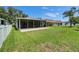 Well-maintained backyard with a screened-in patio, offering a private and comfortable outdoor space for relaxation and entertainment at 10449 Hunters Haven Blvd, Riverview, FL 33578