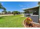 Lush backyard with a view of the screened-in patio, offering a perfect blend of indoor and outdoor living at 10449 Hunters Haven Blvd, Riverview, FL 33578