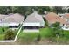 An aerial shot displays a well-maintained backyard with a screened enclosure, nestled between neighboring homes with lush lawns at 10449 Hunters Haven Blvd, Riverview, FL 33578