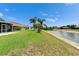 Beautiful backyard with a waterfront view and screened-in patio, providing a serene and private outdoor oasis at 10449 Hunters Haven Blvd, Riverview, FL 33578