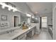 Luxurious en-suite bathroom with double sinks, decorative tiles, and a separate walk-in shower at 10449 Hunters Haven Blvd, Riverview, FL 33578