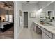 En-suite bathroom featuring double sinks, patterned tile floors, and access to the primary bedroom at 10449 Hunters Haven Blvd, Riverview, FL 33578